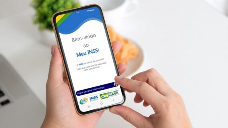 Pessoa acessando o aplicativo Meu INSS pelo celular para solicitar indenização por síndrome do zika vírus