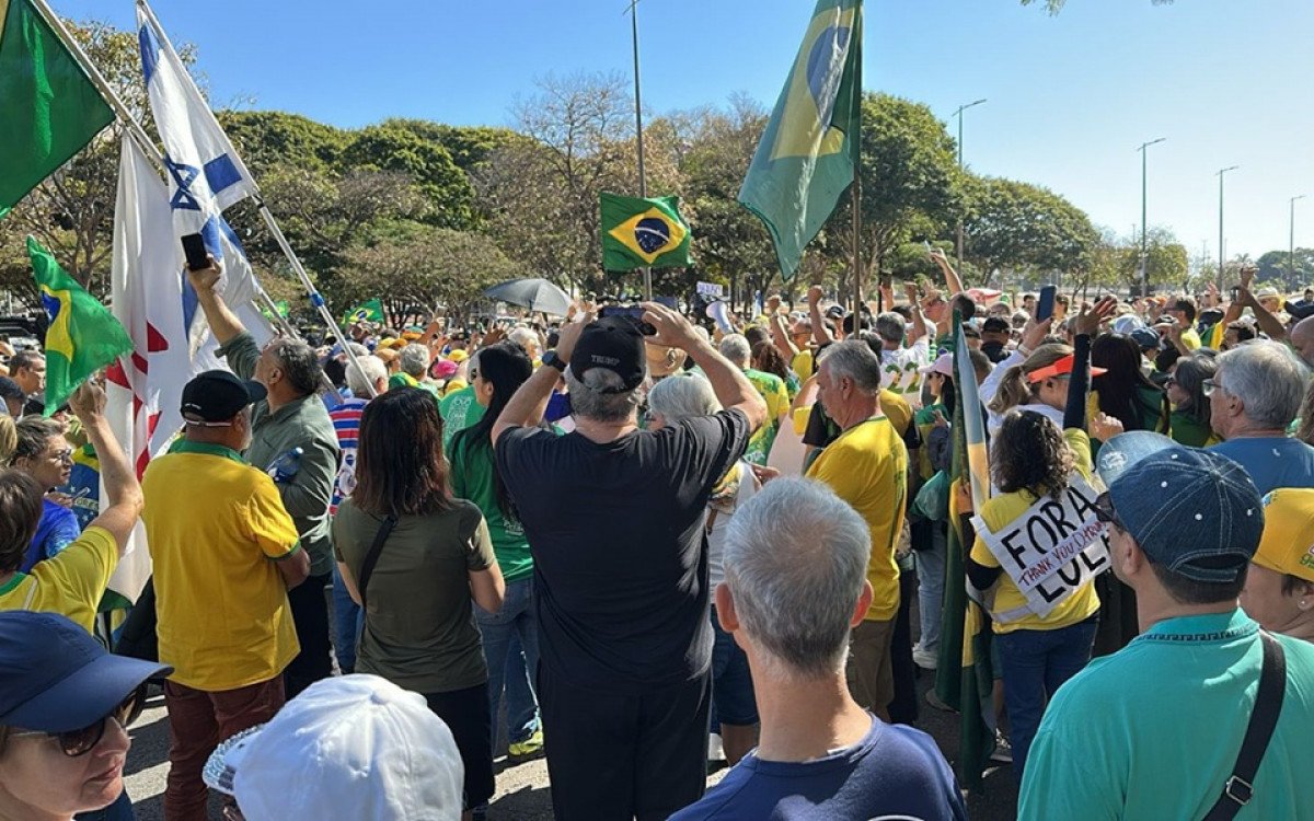 Manifestantes bolsonaristas em Copacabana com cartazes e roupas verde-amarelas pedindo ajuda internacional