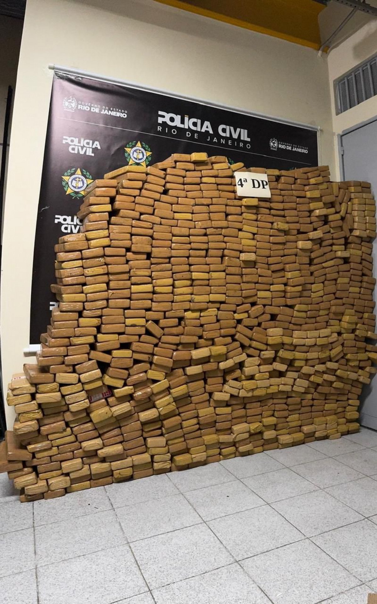 Policiais civis ao lado de carga de maconha apreendida em caminhão-tanque no RJ