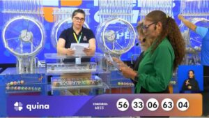 Funcionária Sandra, da Loterias Caixa, juntamente com as auditoras do público, senhoras Cesira Ometto e Maria Félix, realiza o procedimento de conferência e validação do número das bolas sorteadas correspondentes às dezenas que apontam o resultado do concurso 6855 da Quina | Reprodução/Youtube/Loterias Caixa