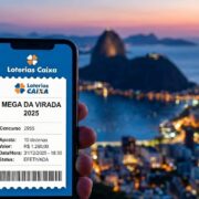 Mão em primeiro plano segurando um smartphone que exibe a tela de confirmação de aposta do aplicativo Loterias Caixa. Na tela, lê-se 'Mega da Virada 2025', 'Concurso 2955', com o detalhamento de 'Aposta: 10 dezenas' e o valor de 'R$ 1.260,00' com status 'Efetivada'. O fundo da imagem mostra uma vista panorâmica e desfocada do Pão de Açúcar, no Rio de Janeiro, durante o pôr do sol, banhando a cena com tons alaranjados e dourados.