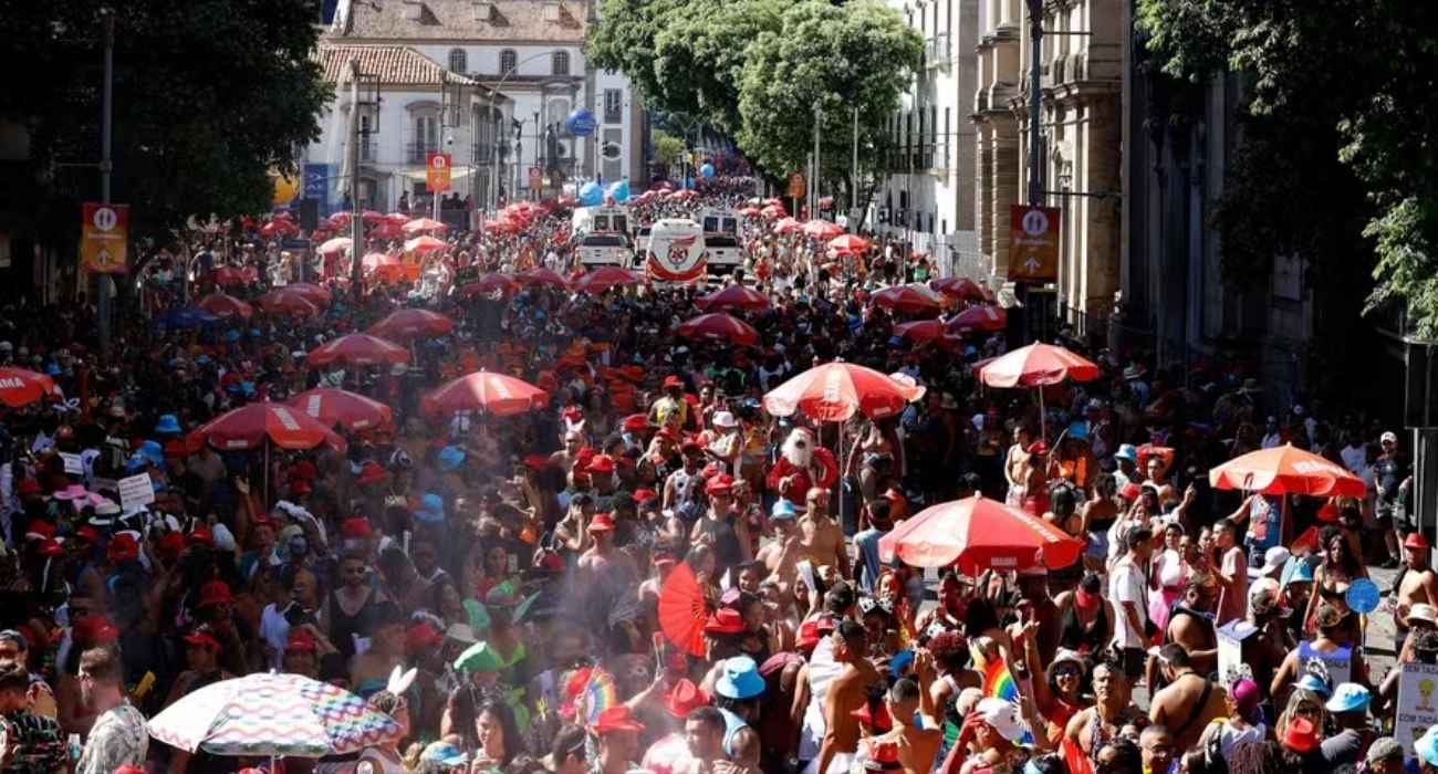 Pessoas comemoram o Carnaval enquanto trabalhadores tiram dúvidas sobre feriado