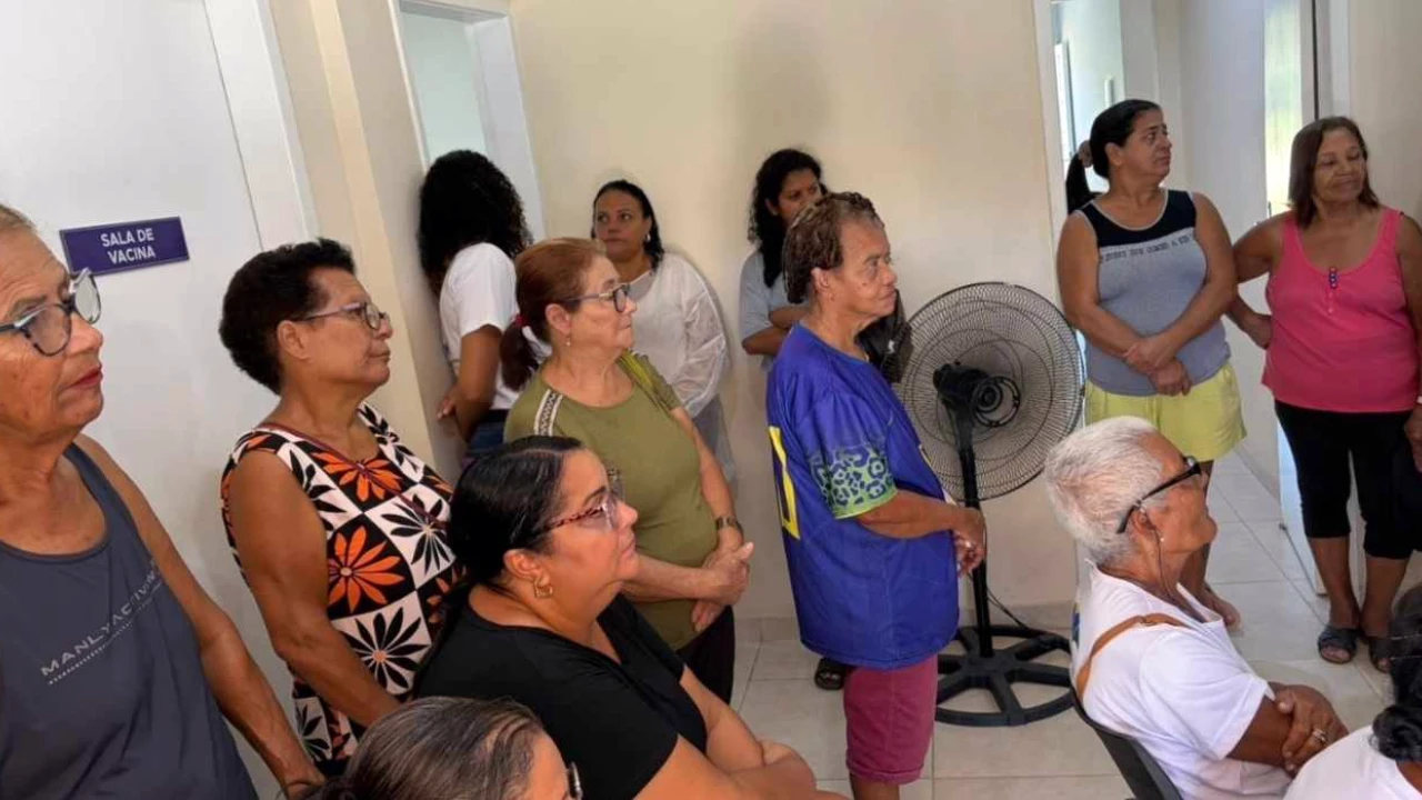 Profissional de saúde mede pressão arterial em paciente em unidade básica