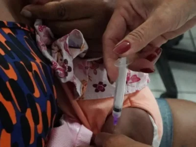 Profissional de saúde aplica vacina em criança durante campanha de multivacinação em São Gonçalo