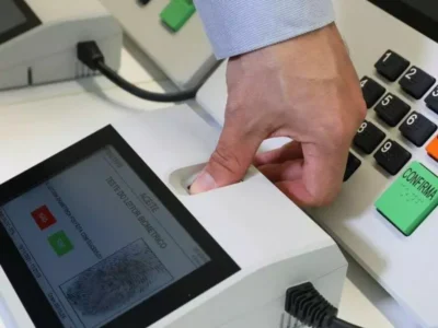 Eleitor faz identificação biométrica na urna eletrônica antes de votar nas Eleições 2026
