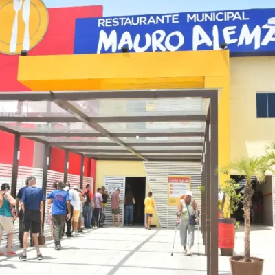 Fachada do Restaurante Municipal Mauro Alemão, em Inoã, Maricá, com usuários na entrada