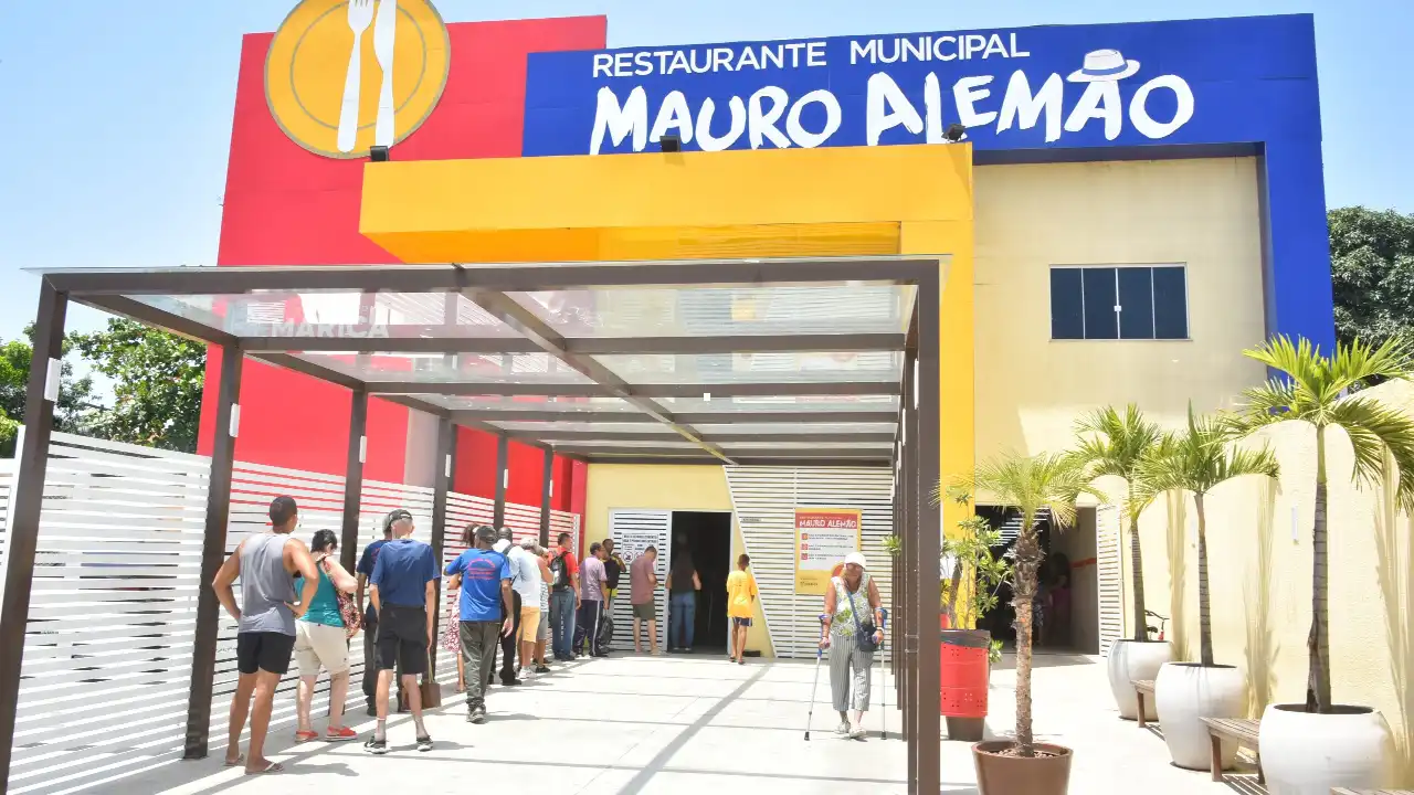 Fachada do Restaurante Municipal Mauro Alemão, em Inoã, Maricá, com usuários na entrada Fachada do Restaurante Municipal Mauro Alemão, em Inoã, Maricá, com usuários na entrada