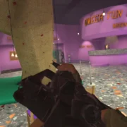 Cena de Airsoft Allstars em primeira pessoa mostra jogador com equipamento virtual de airsoft dentro de uma arena colorida chamada Omega Fun Center.