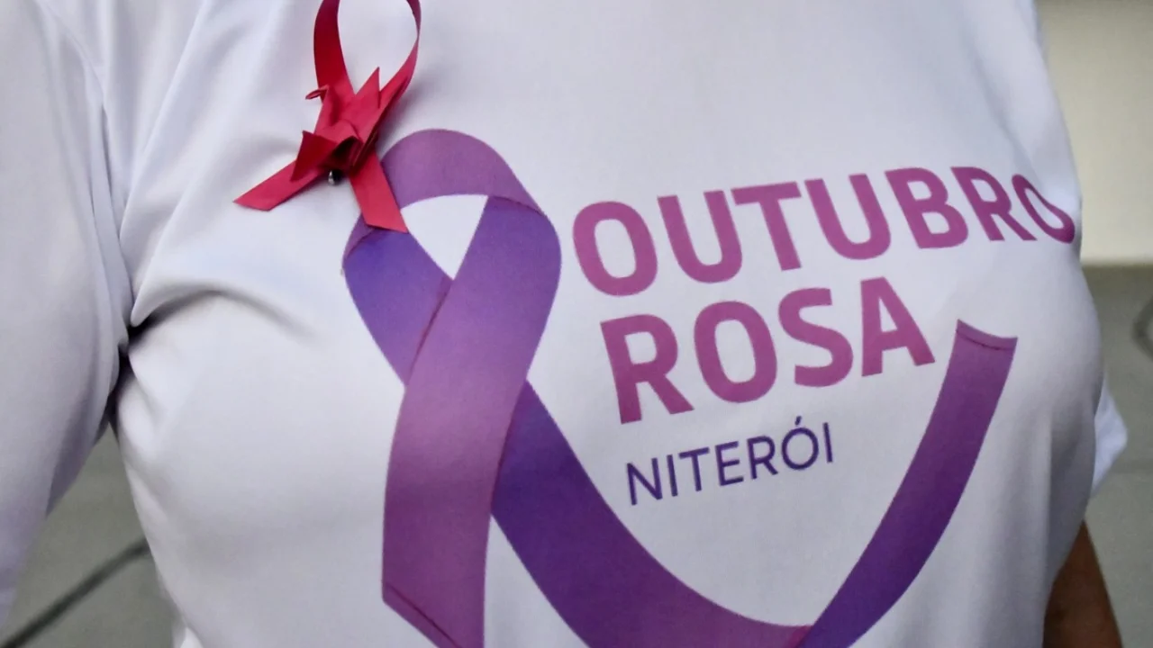 Mulher realiza mamografia com auxílio de profissional de saúde