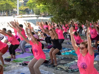 Mulheres participam de aula de Yoga na praia durante programação do Outubro Rosa em Niterói