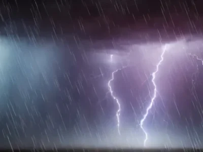 Raios iluminam o céu escuro durante uma tempestade, com chuva intensa e nuvens carregadas.