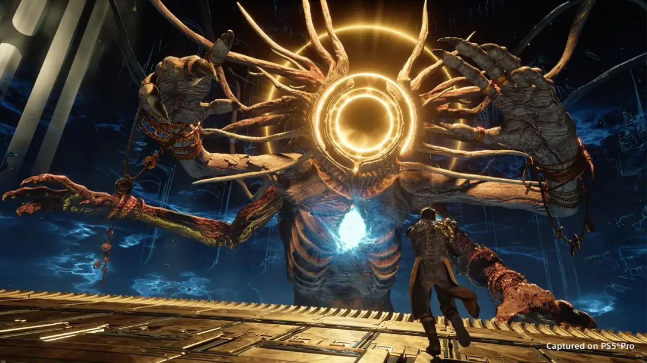 Chefe gigante de Saros com múltiplos braços e círculos luminosos dourados enfrenta o protagonista em arena de combate no PS5 Pro. Chefe gigante de Saros com múltiplos braços e círculos luminosos dourados enfrenta o protagonista em arena de combate no PS5 Pro.